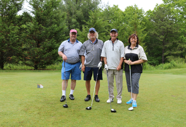 photo of foursome at golf tournament